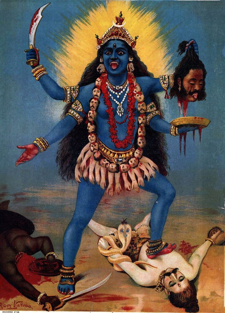 A painting of Kali, a blue-skinned, four-armed Hindu goddess. She wields a scimitar in one hand, a severed head in another, and is adorned with jewels and severed heads.